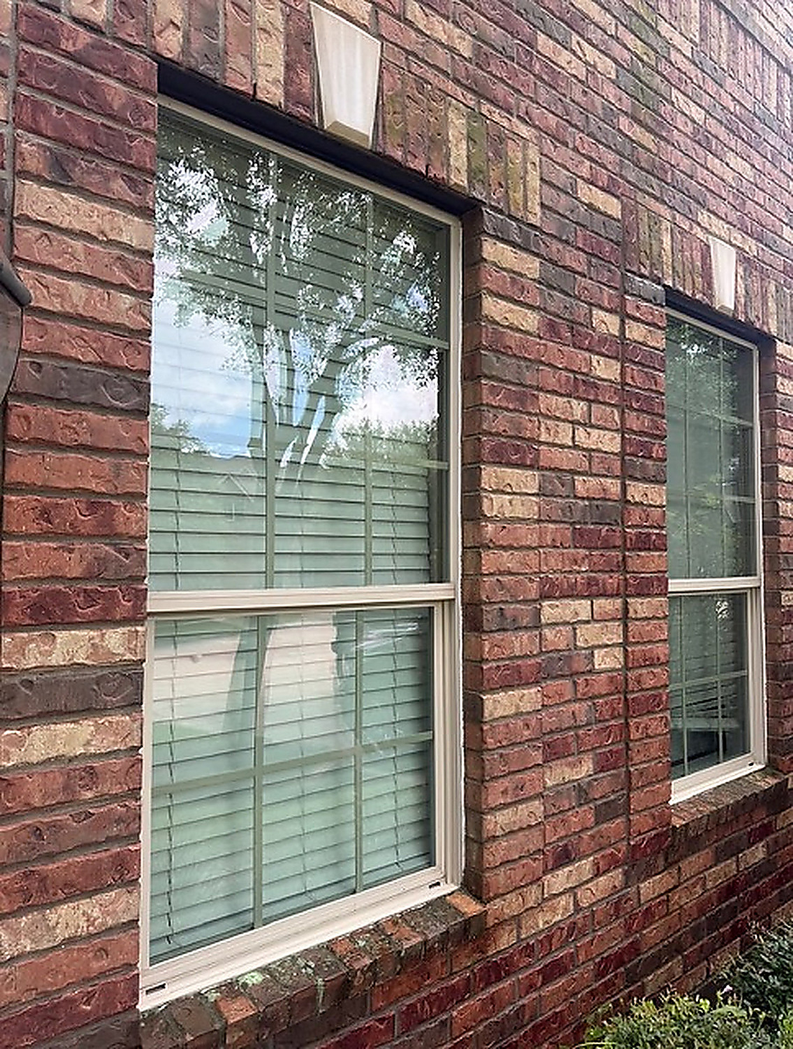 Exterior window cleaning on brick home
