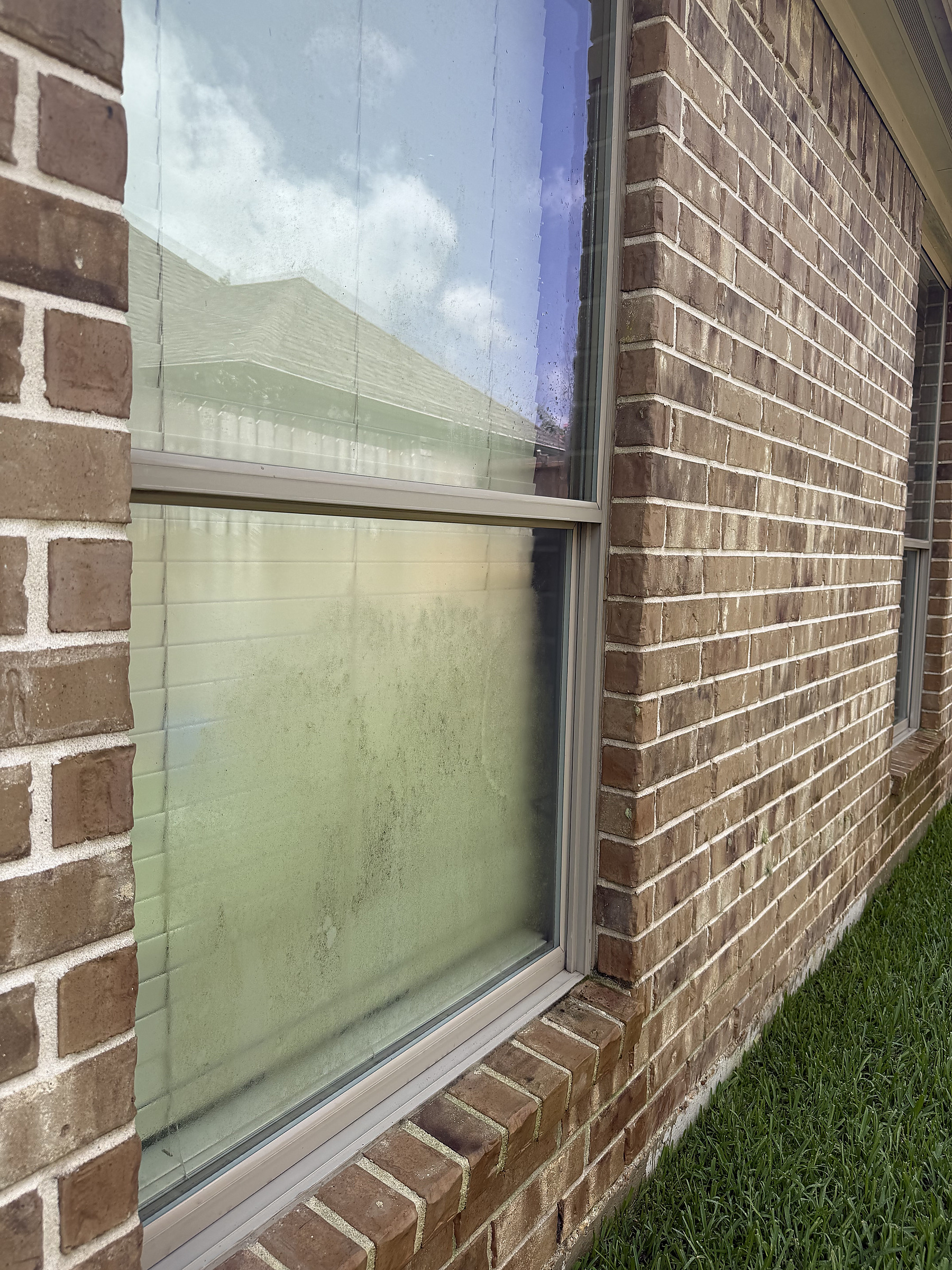 Before brick home window cleaning