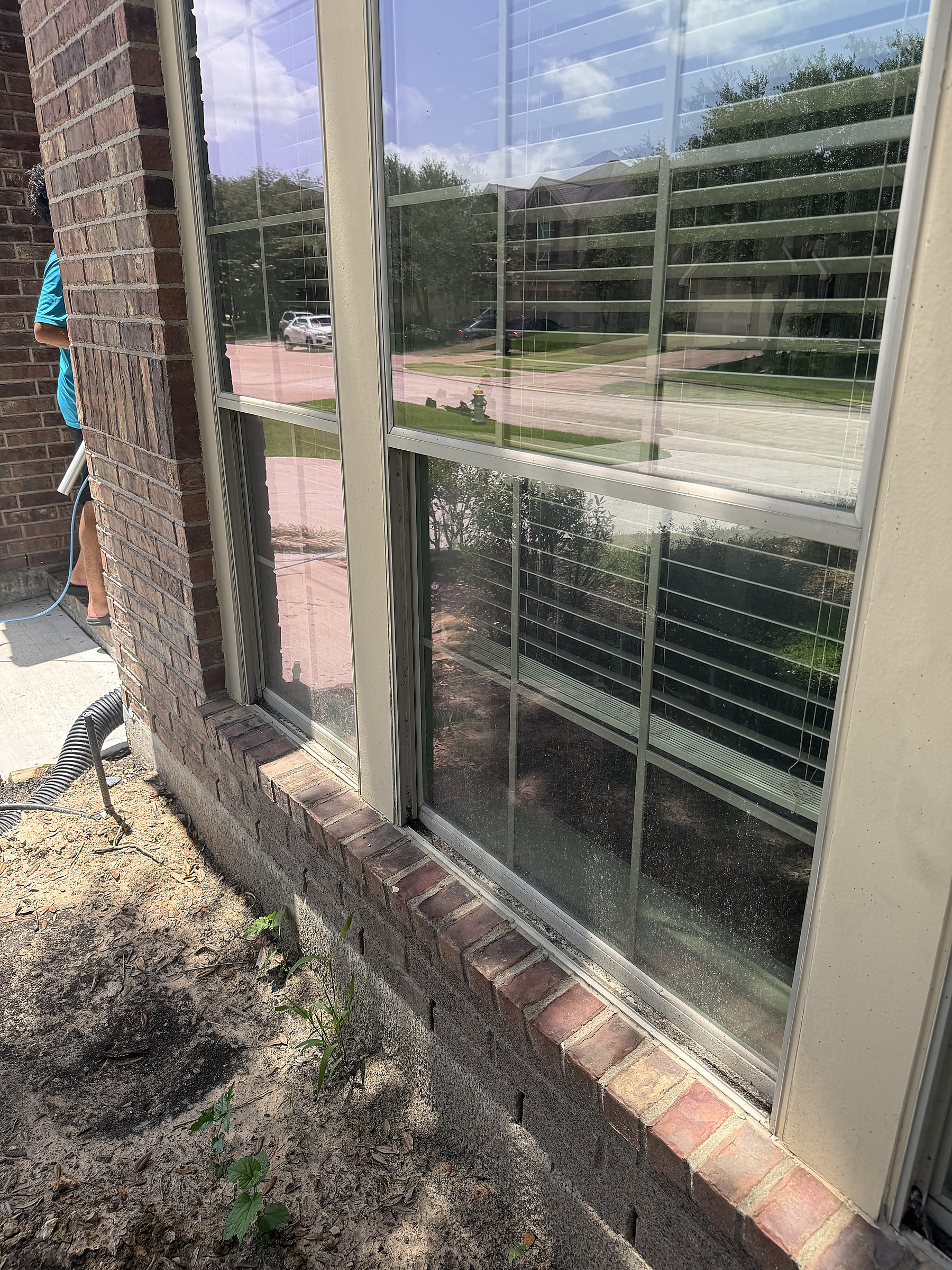 Window cleaning service on brick home